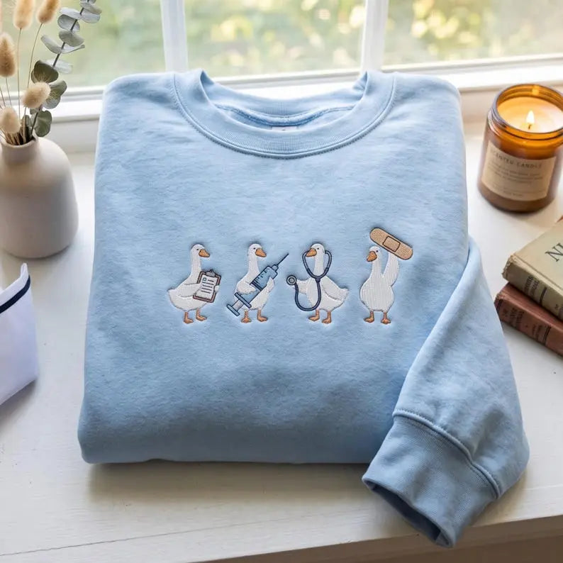 Original folded light blue sweatshirt with four medical ducks