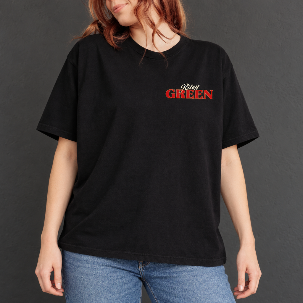 Auburn-haired model wearing the black tee, front view