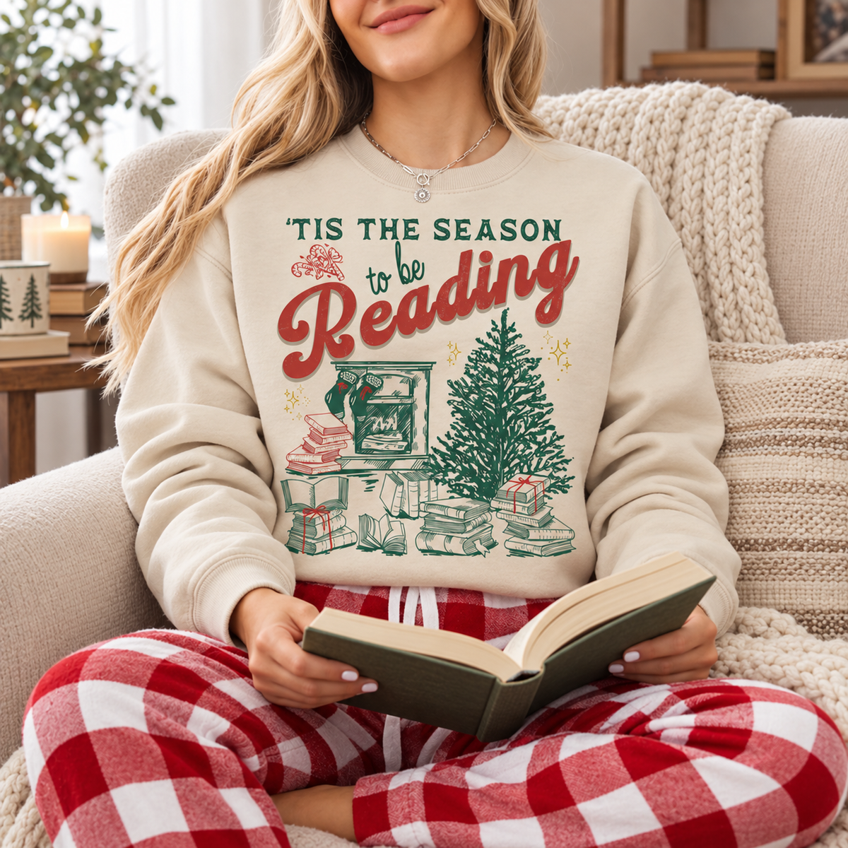 Same model wearing the sand sweatshirt while reading