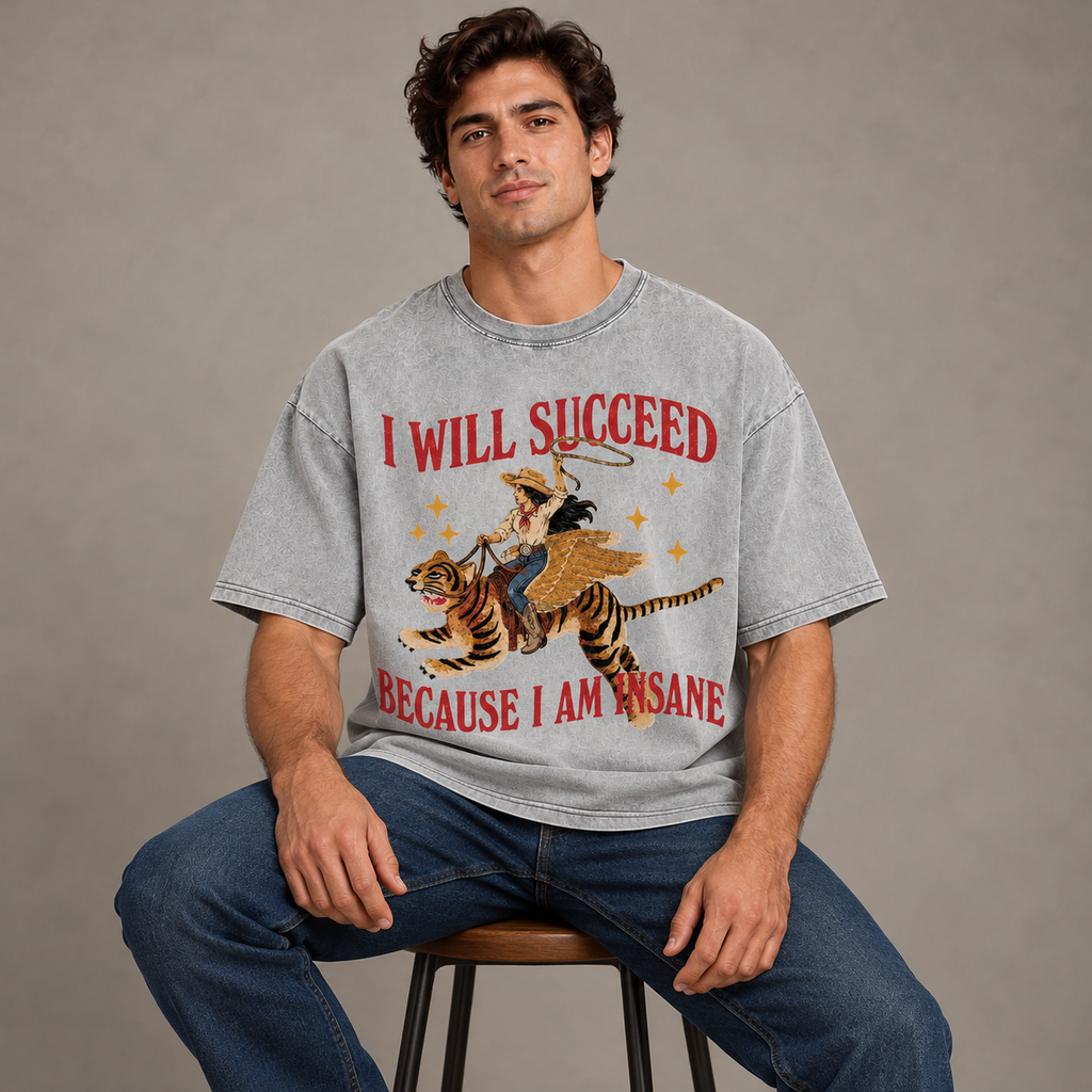 Same male model seated wearing the gray graphic tee