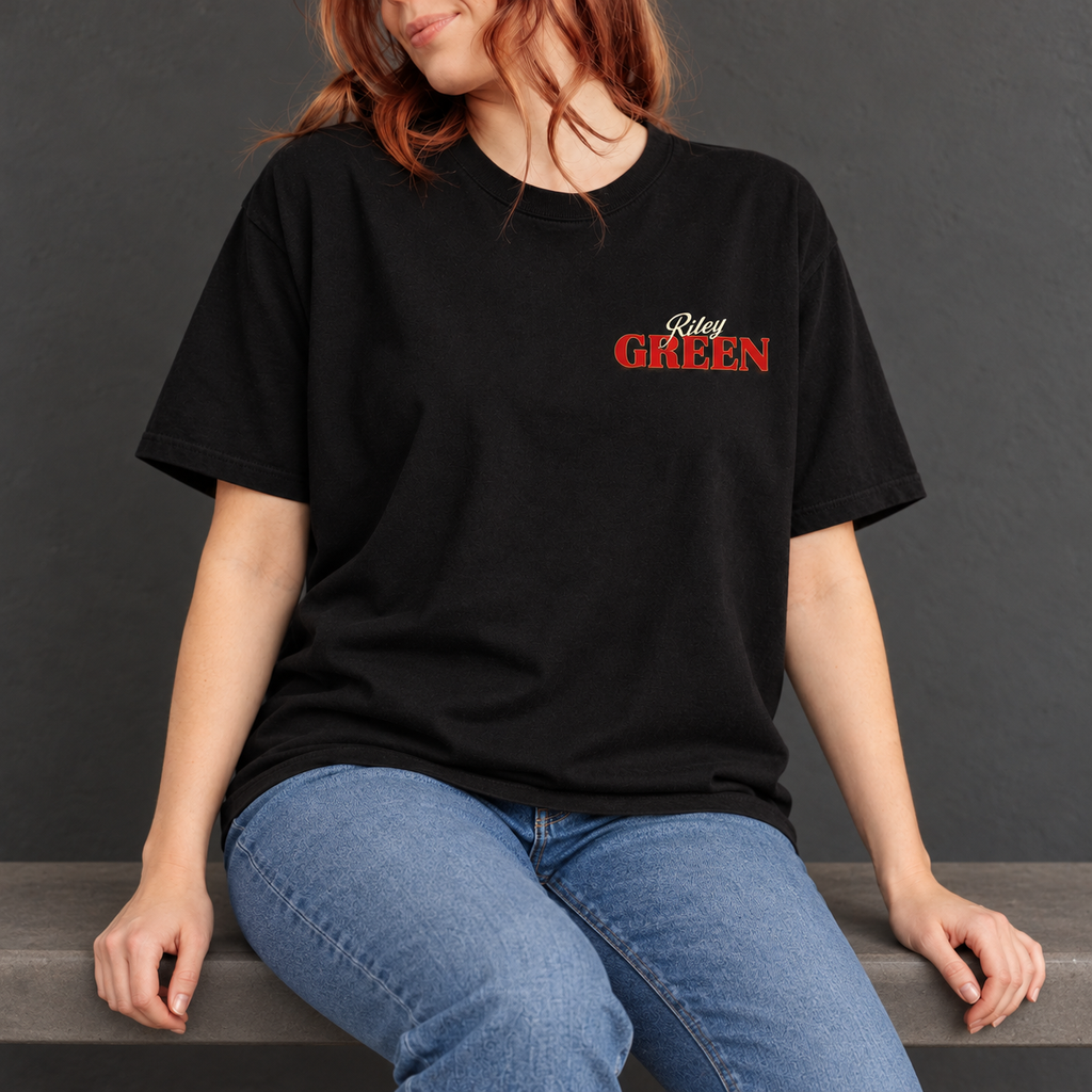 Same model seated wearing the black tee