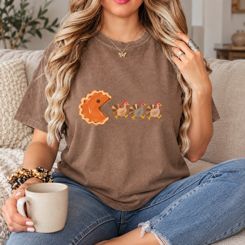 Same female model seated wearing the espresso graphic tee