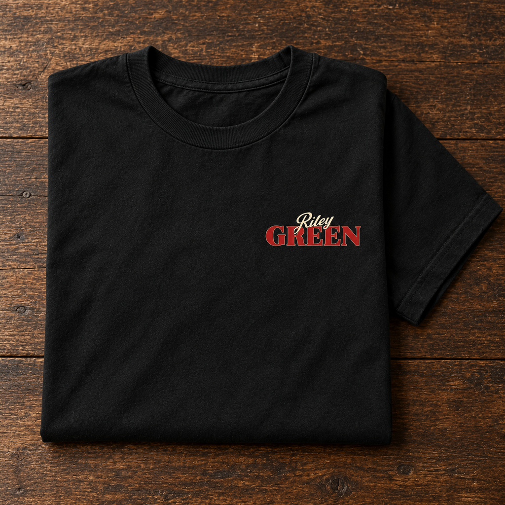 Black graphic tee folded on a wooden surface