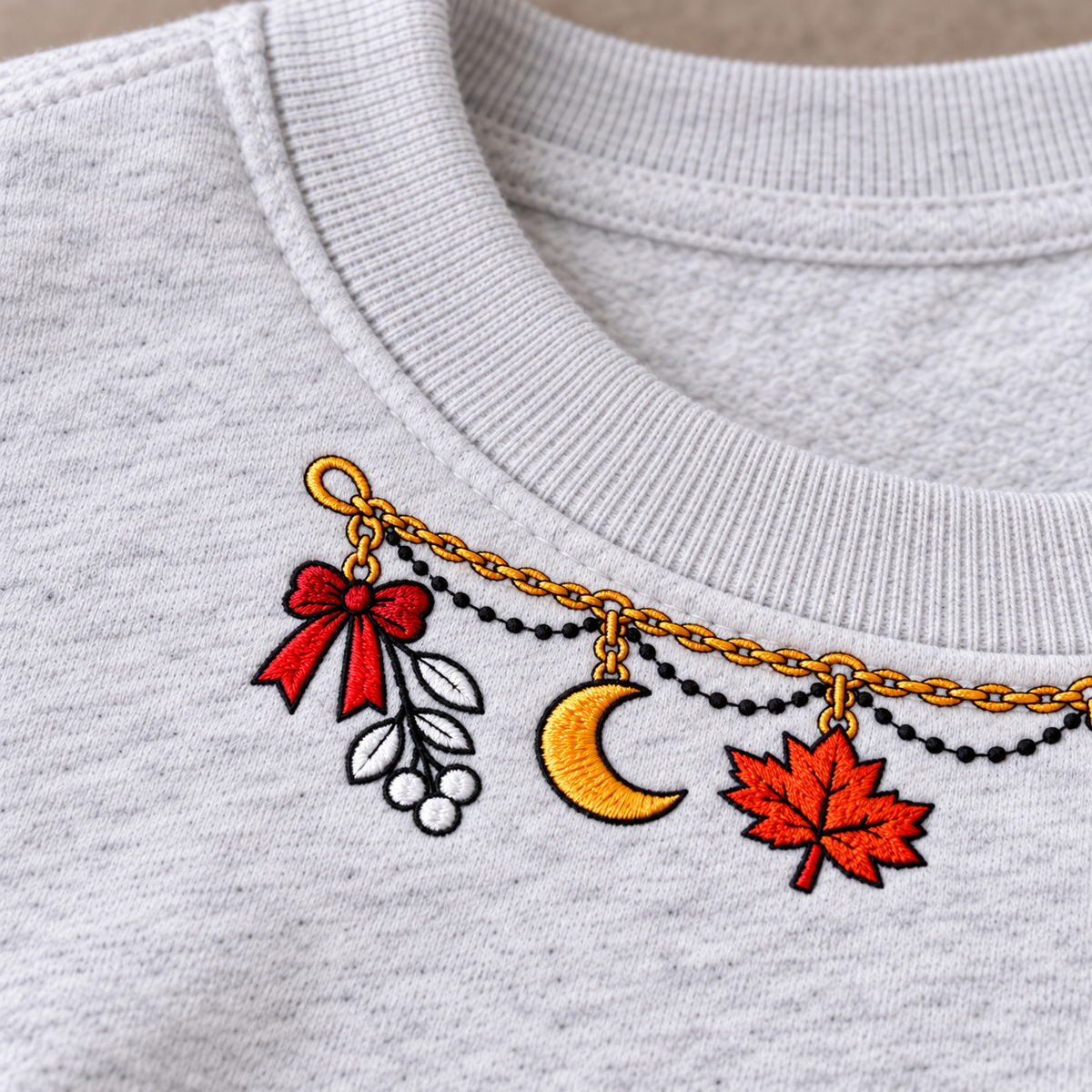Close-up of small shallow gold chain embroidery and red bow detail